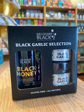 Neudorf Black Garlic Selection on a wooden surface with grocery store background